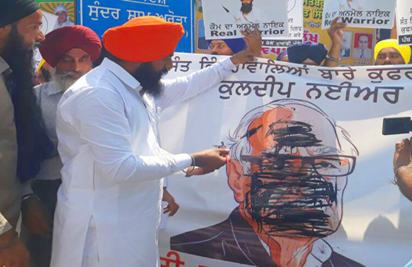 Angered at Nayyar’s comparison between Sant Bhindrawale and Ram Rahim, SYP blackened his picture in Hoshiarpur