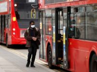 A man wearing a face mask getting on the bus, as the spread of the coronavirus disease (COVID-19) continues, as the spread of the coronavirus disease (COVID-19) continues, London, Britain, April 17, 2020. REUTERS/John Sibley