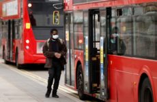 A man wearing a face mask getting on the bus, as the spread of the coronavirus disease (COVID-19) continues, as the spread of the coronavirus disease (COVID-19) continues, London, Britain, April 17, 2020. REUTERS/John Sibley