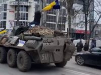 Ukrainian man climbs onto Russian tank, waves national flag as crowd cheers | Video